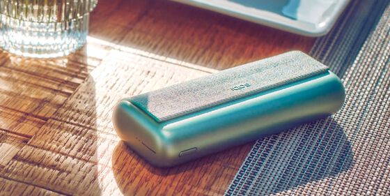 An IQOS ILUMA Pocket Charger in a charging station.