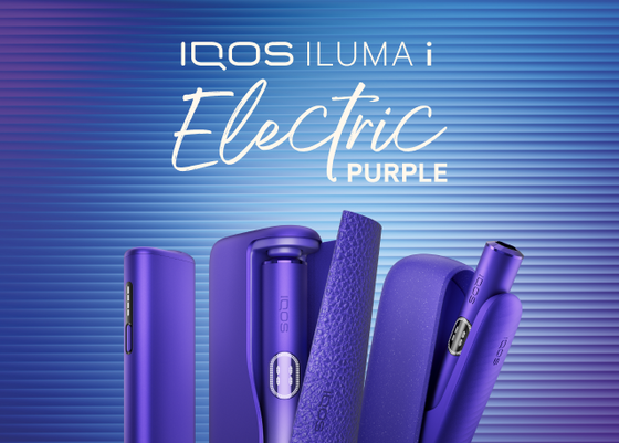 A blue IQOS device on a wooden table. 