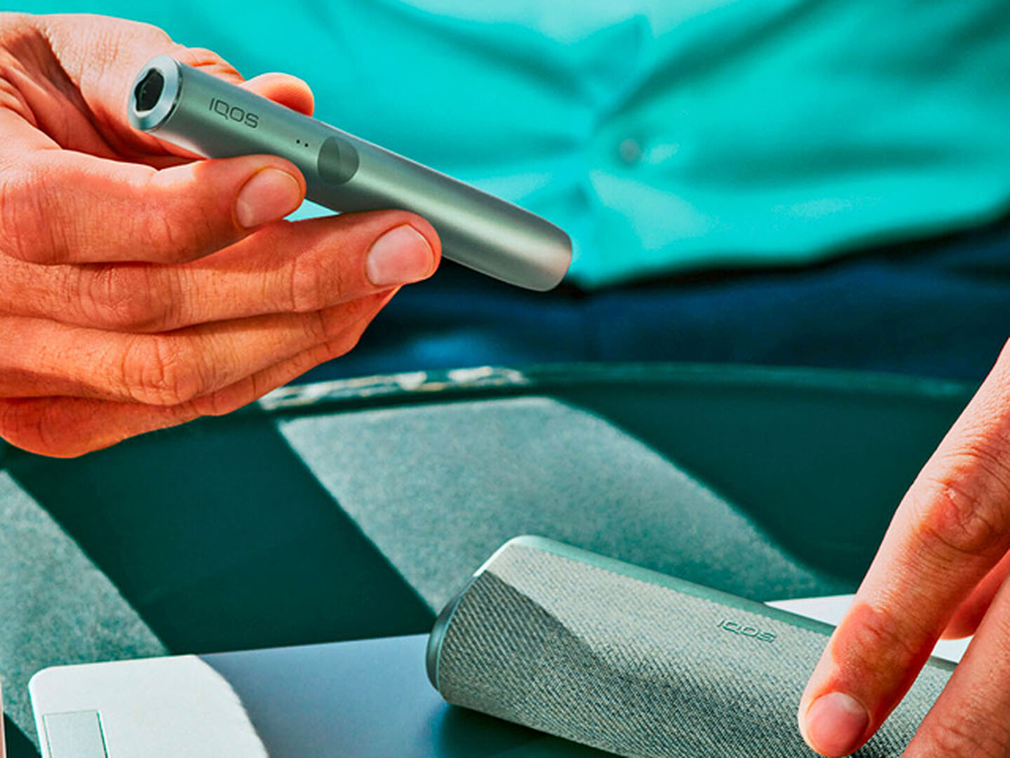 An IQOS ILUMA Pocket Charger in a charging station. 