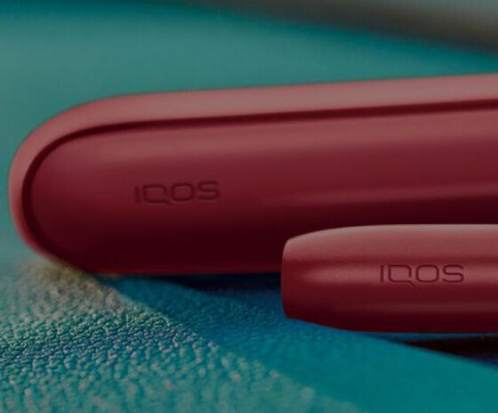 IQOS packaging on a glass table